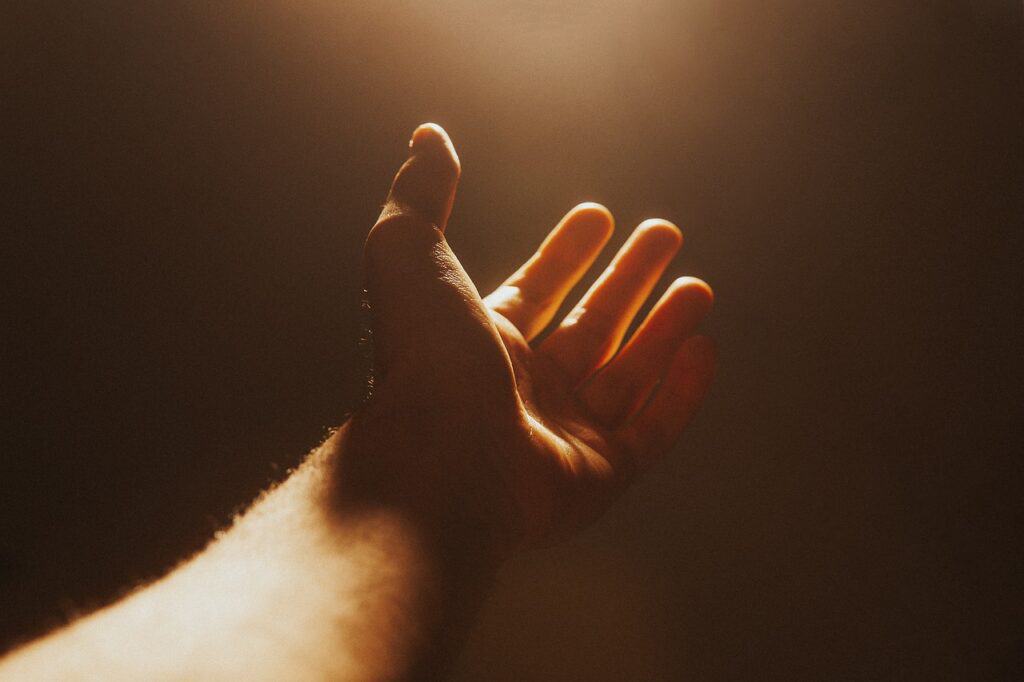 Hand reaching towards the light