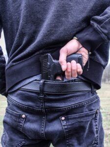 Man armed with gun in the back of his pants