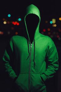 Person wearing hoodie in the dark, mimicking Paul Bernardo as the Scarborough Rapist