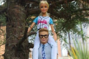 Barbie on Ken's shoulders, representing the ken and barbie killers