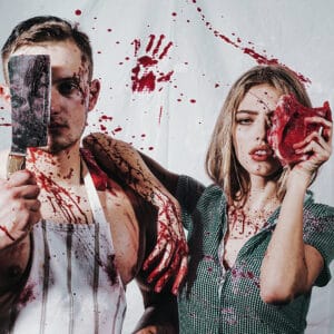 two bloody cannibals holding meat, showing legal dangers of cannibalism