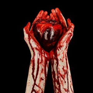 Notorious cannibals holding a heart