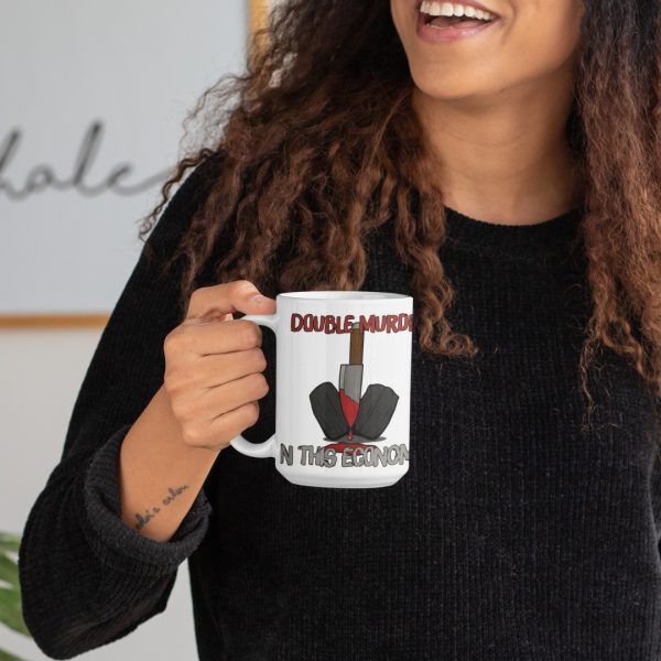 woman holding double murder true crime mug and smiling