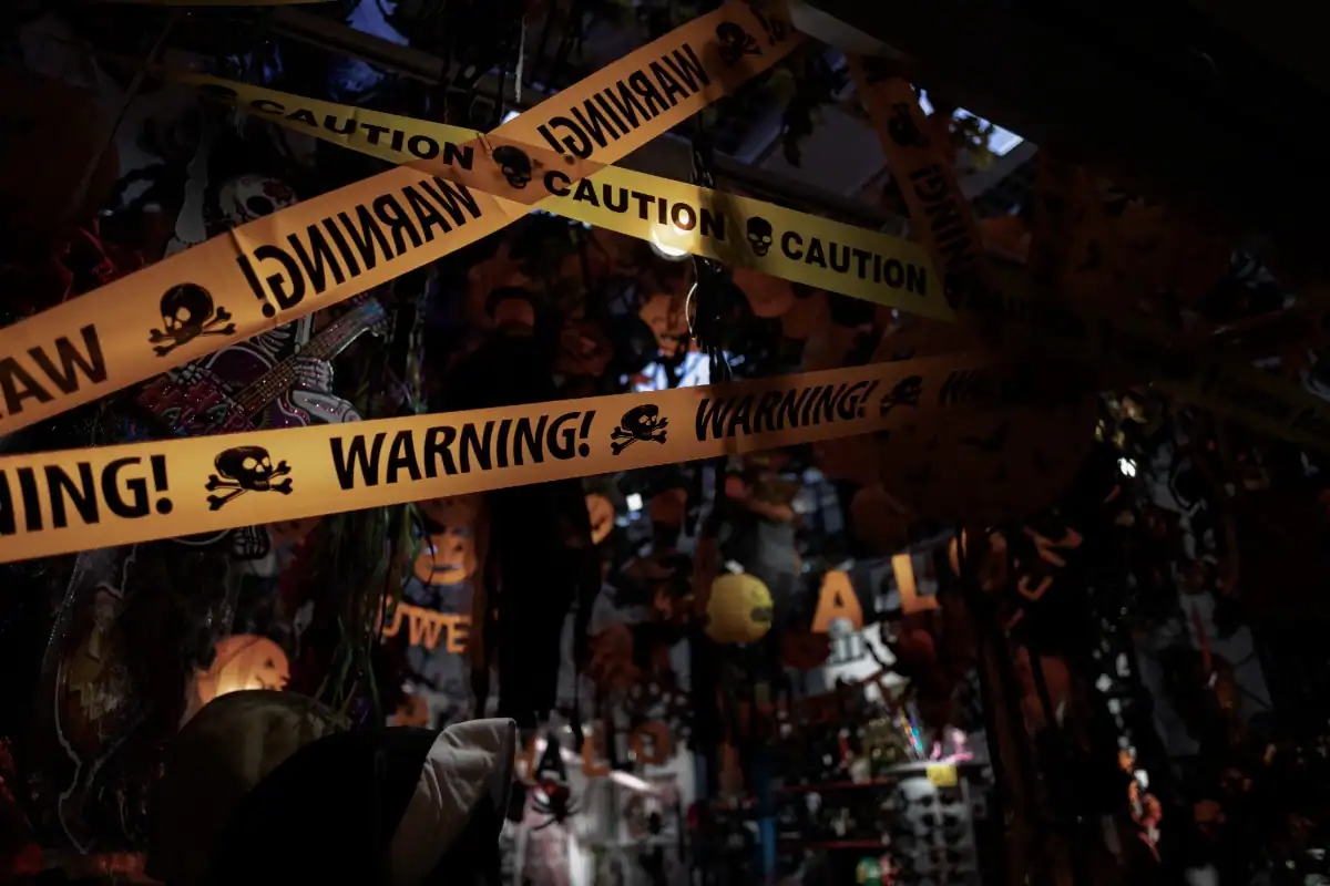 crime scene tape accross halloween decorations symbolizing halloween crime