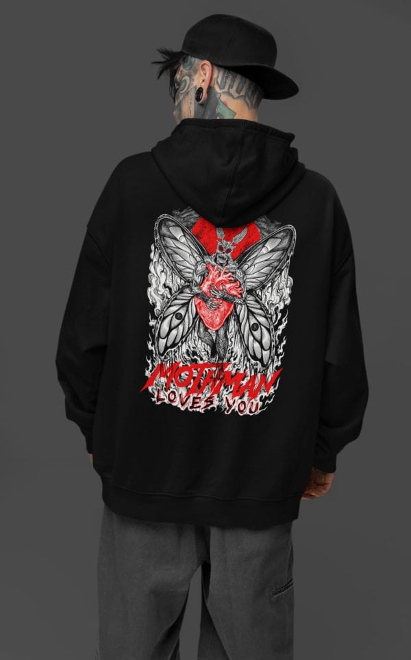 tattooed man in nu goth wear rocking black hood mothman fan hooded sweatshirt