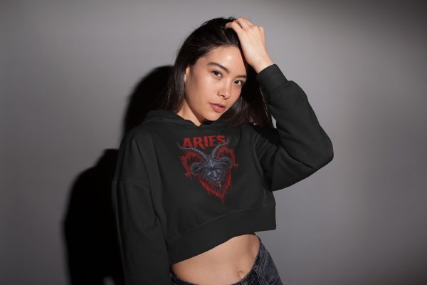 alternative woman in sexy pose while wearing the black cropped aries hoodie