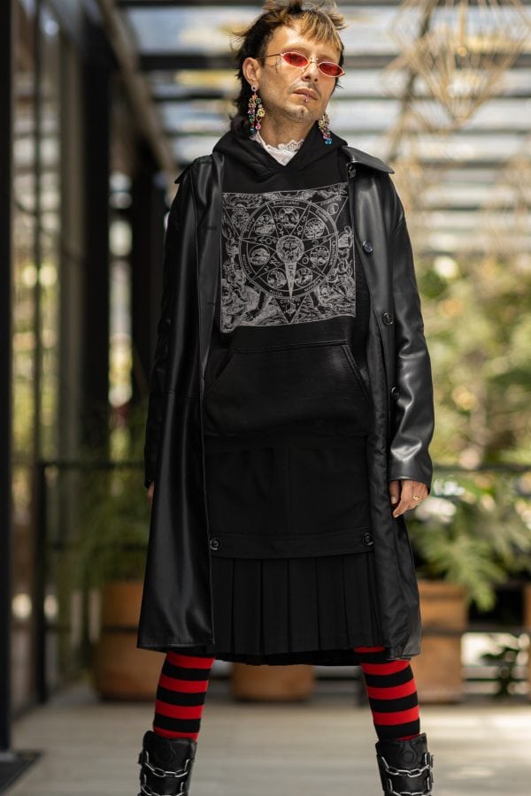 Goth persona striking pose in alternative style alchemy hoodie with azoth mandala design