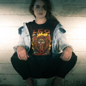 grunge style woman wearing horror art style leo astrology sign t-shirt