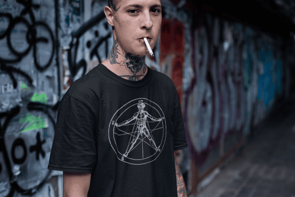 alt male wearing agrippa's pentagram occult t-shirt in graffiti tunnel