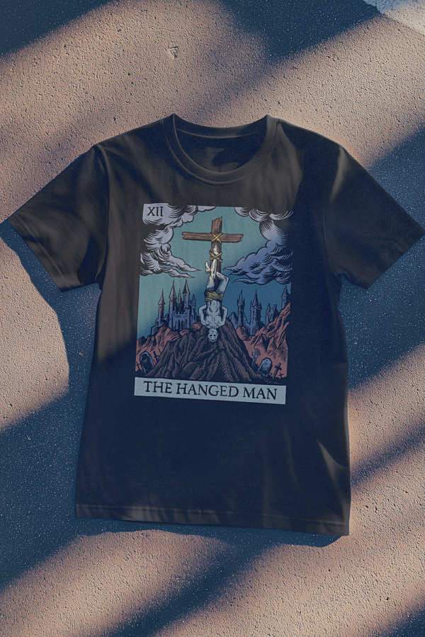 the hanged man tarot t-shirt lying on the street in the shadows
