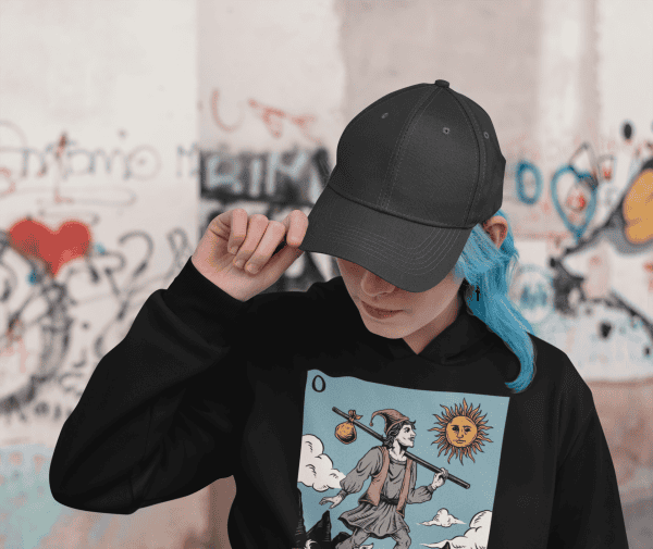 alt girl style woman with blue hair wearing the fool tarot card design hoodie by obscurix