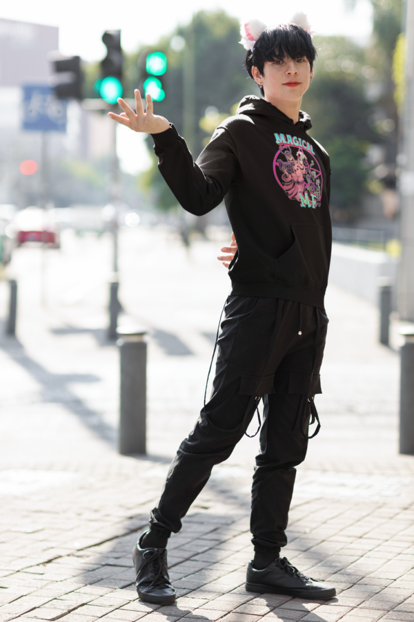 alternative style goth man posing in magical mf hoodie and cat ears