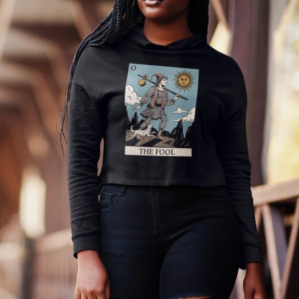Goth woman wearing the fool tarot cropped hoodie while walking on a bridge