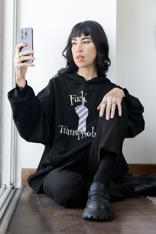 goth woman taking selfie while wearing black fuck transphobes hoodie