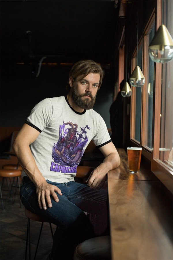 grunge punk wearing retro ringer with horror capricorn graphic print while sitting at the bar