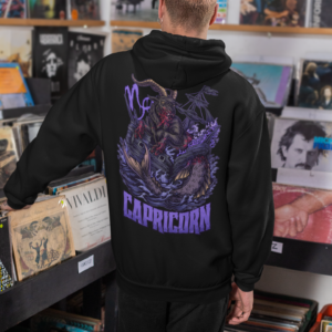 punk man perusing record store while wearing alt style capricorn zodiac hoodie