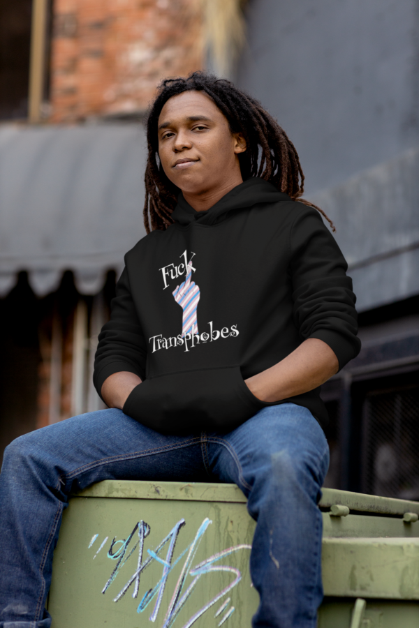 skater punk wearing fuck transphobes hoodie and sitting on dumpster