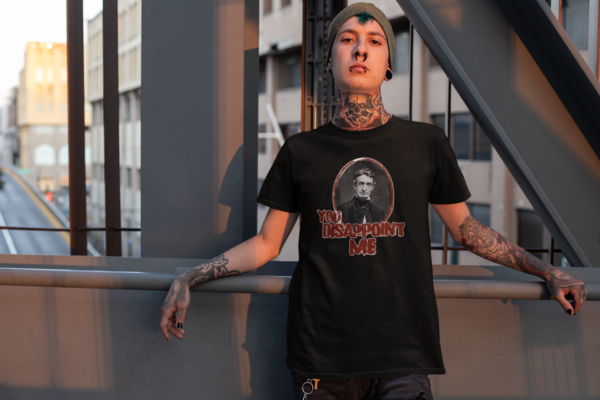 tattooed alternative man in funny john brown t shirt for leftists