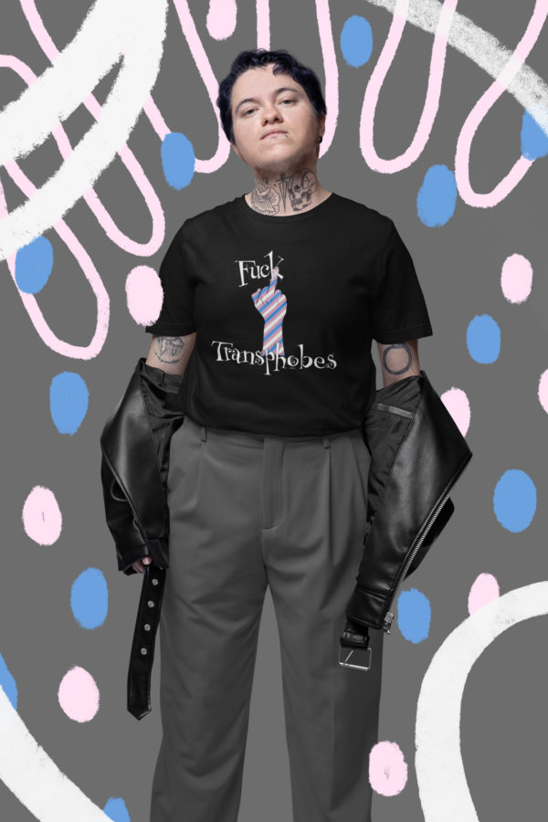 goth punk trans man wearing funny leftist t-shirt that says fuck transphobes